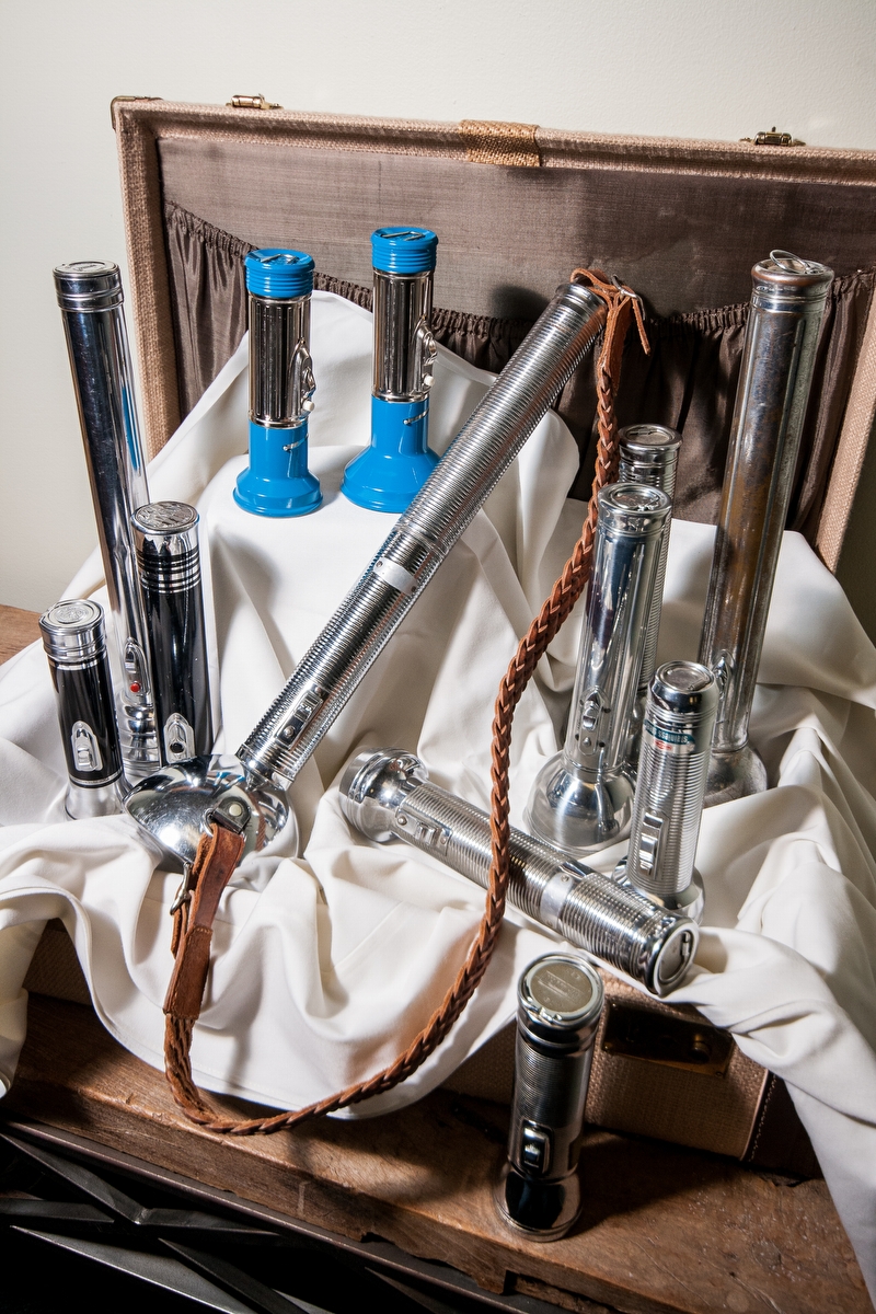 A collection of vintage flashlights from large to small